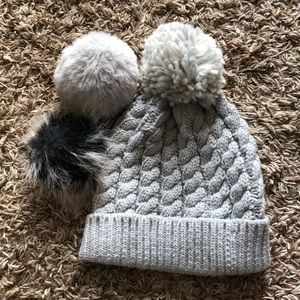 Gray stocking hat with three interchangeable pompoms.